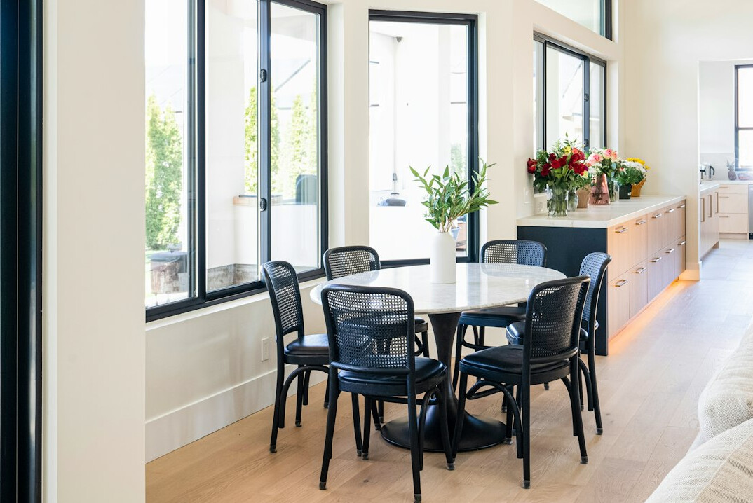 Bright designer interior with a dining area and large windows