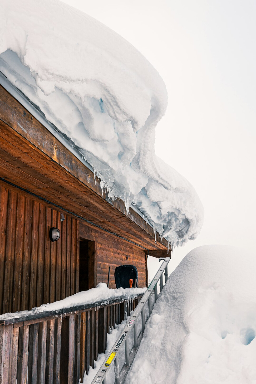 Snowy mountain chalet with wooden balconies
