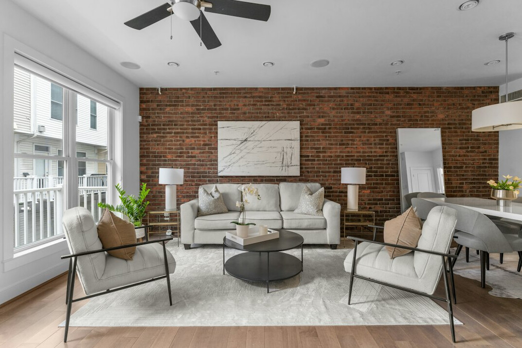 Bright apartment living area with a sofa and a large window