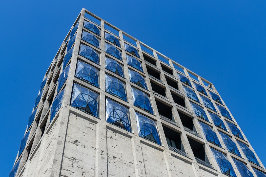 Modern concrete and glass building seen from below