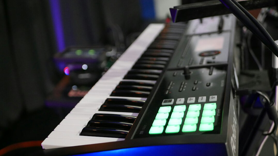 Creative home music studio with synthesizers and speakers