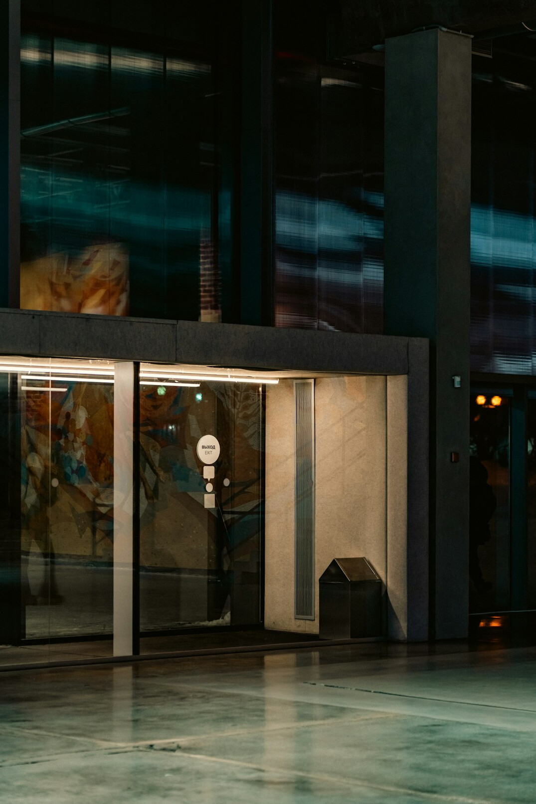 Contemporary house with large glass windows and a lit entrance